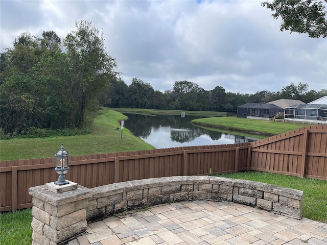 view of patio / terrace with a fenced backyard and a water view