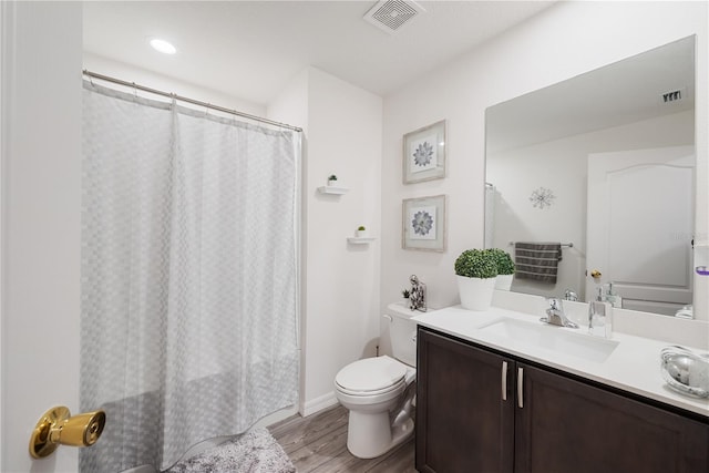 8975 Southern Charm Cir, Brooksville, FL 34613 - bathroom with visible vents, wood finished floors, toilet, and vanity