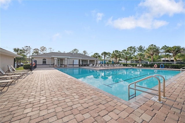 8975 Southern Charm Cir, Brooksville, FL 34613 - community pool featuring a patio and fence