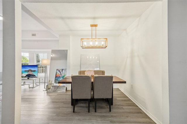 105 W Columbus Dr, Tampa, FL 33602 - dining space featuring visible vents, baseboards, an inviting chandelier, and wood finished floors