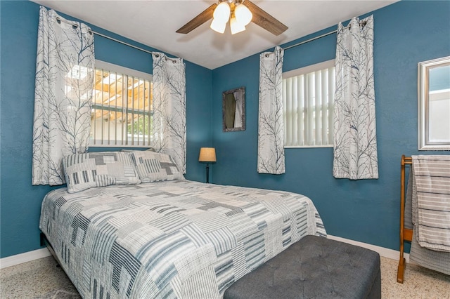 bedroom featuring speckled floor, baseboards, and ceiling fan