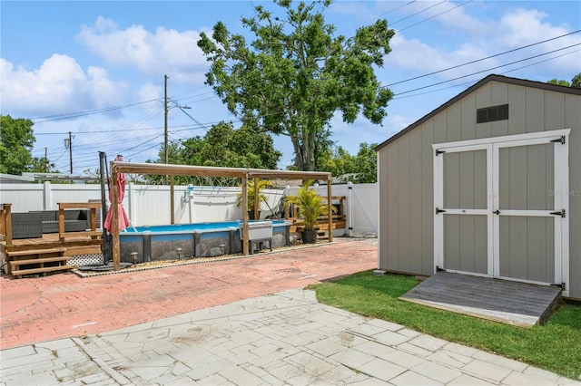 view of shed featuring a fenced in pool and a fenced backyard