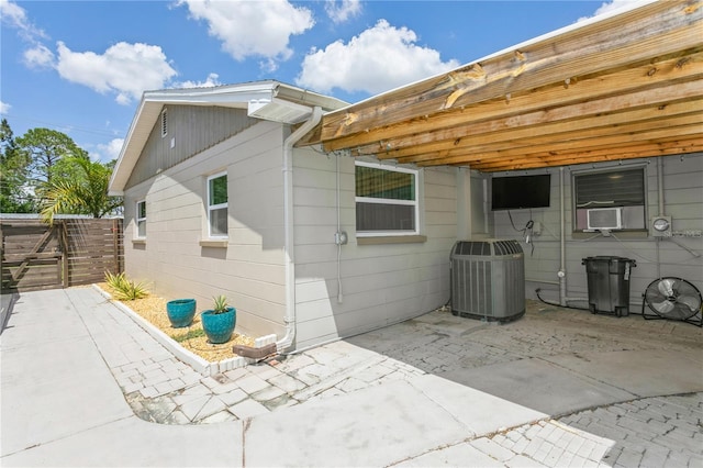 rear view of property with a patio area, central AC, cooling unit, and fence