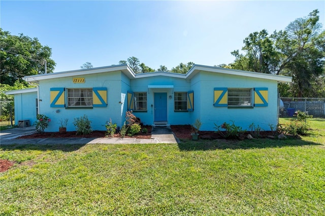 17111 Mockingbird Ln, Lutz, FL 33548 - view of front facade featuring a front yard and fence