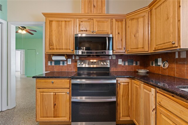17111 Mockingbird Ln, Lutz, FL 33548 - kitchen with a ceiling fan, backsplash, visible vents, dark stone counters, and appliances with stainless steel finishes