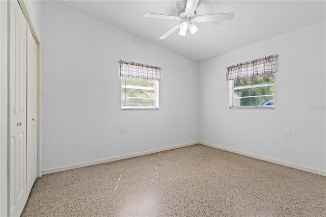 17111 Mockingbird Ln, Lutz, FL 33548 - unfurnished bedroom with a closet, baseboards, speckled floor, and ceiling fan