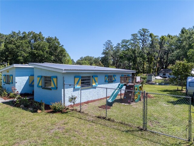 17111 Mockingbird Ln, Lutz, FL 33548 - back of house featuring a yard, fence, and a playground