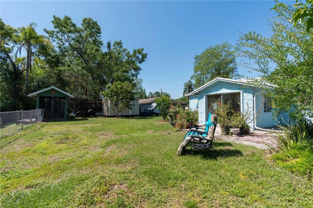 17111 Mockingbird Ln, Lutz, FL 33548 - view of yard featuring fence, an outdoor structure, and a storage unit
