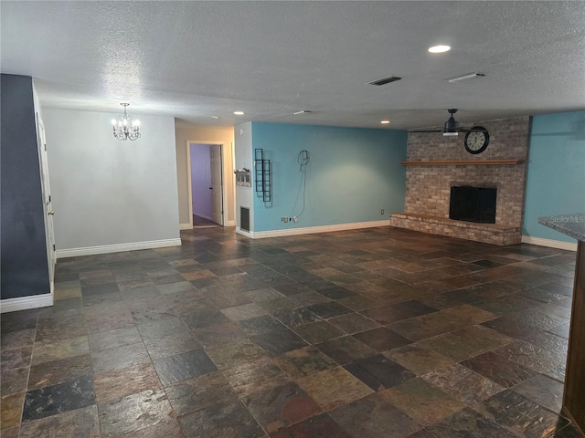 unfurnished living room with a textured ceiling, an inviting chandelier, and baseboards