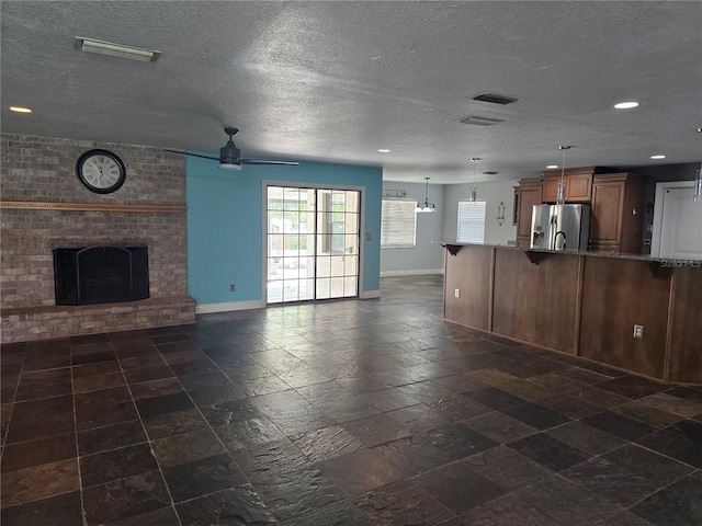 unfurnished living room featuring baseboards, a ceiling fan, recessed lighting, and a fireplace