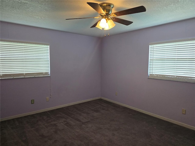 unfurnished room featuring baseboards, a ceiling fan, carpet, and a textured ceiling