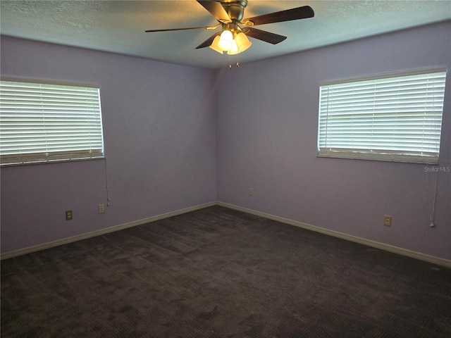 empty room featuring carpet flooring, baseboards, a ceiling fan, and a textured ceiling