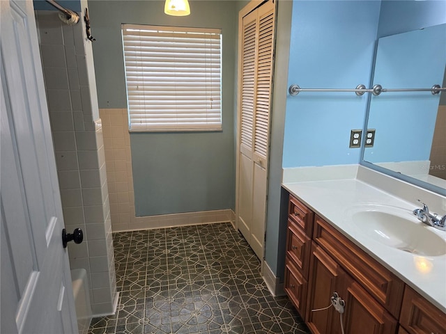 bathroom featuring tile patterned floors, vanity, and walk in shower