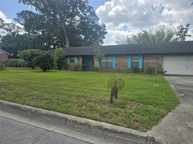 ranch-style house with a garage, brick siding, a front lawn, and concrete driveway