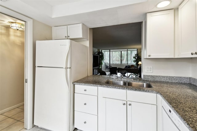 kitchen with baseboards, white appliances, light tile patterned floors, white cabinetry, and a sink