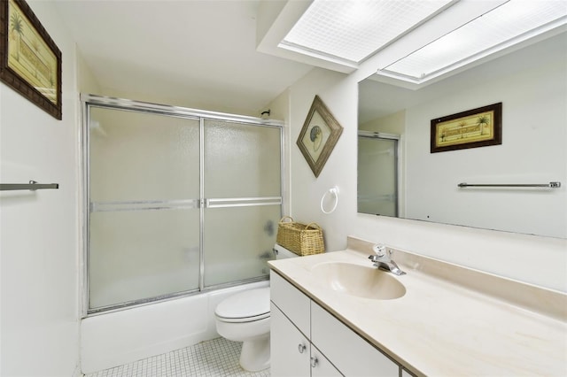 full bath featuring toilet, tile patterned flooring, enclosed tub / shower combo, and vanity