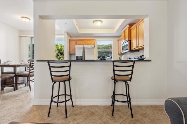 456 Bahia Beach Blvd, Ruskin, FL 33570 - kitchen with a kitchen bar, appliances with stainless steel finishes, and dark countertops