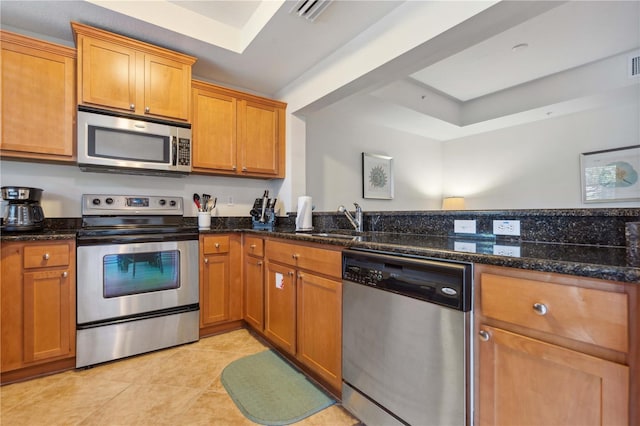 456 Bahia Beach Blvd, Ruskin, FL 33570 - kitchen featuring light tile patterned floors, visible vents, brown cabinets, and appliances with stainless steel finishes