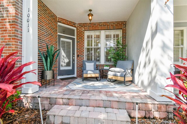 10011 Parley Dr, Tampa, FL 33626 - entrance to property featuring covered porch and brick siding