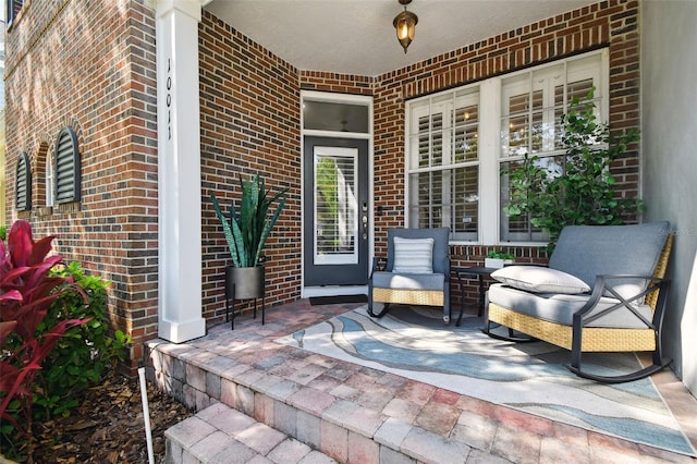 10011 Parley Dr, Tampa, FL 33626 - view of exterior entry with brick siding and a porch