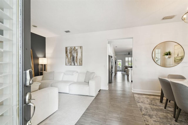 10011 Parley Dr, Tampa, FL 33626 - living area featuring wood finished floors, baseboards, and visible vents