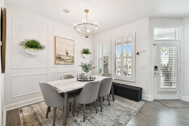 10011 Parley Dr, Tampa, FL 33626 - dining room featuring baseboards, an inviting chandelier, and wood finished floors