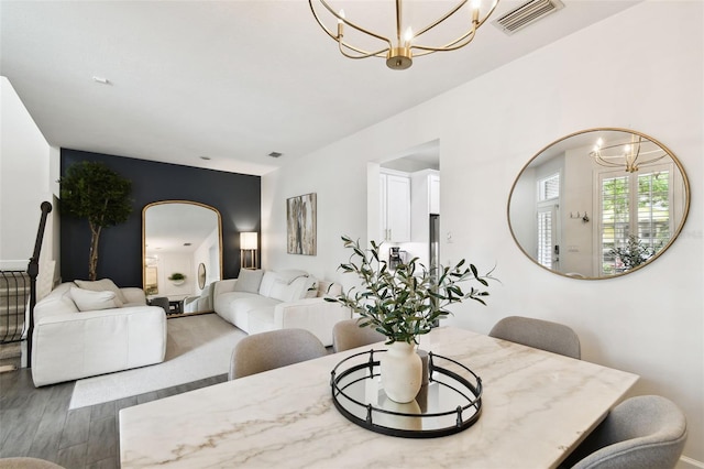 10011 Parley Dr, Tampa, FL 33626 - dining room with a chandelier, arched walkways, wood finished floors, and visible vents