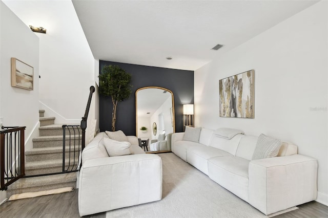 10011 Parley Dr, Tampa, FL 33626 - living area featuring stairway, visible vents, baseboards, and wood finished floors