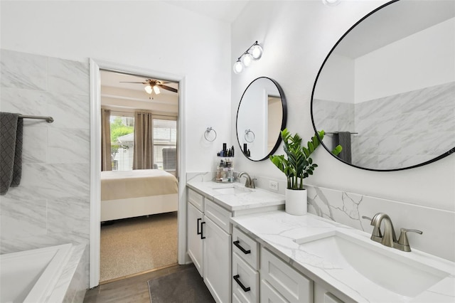 10011 Parley Dr, Tampa, FL 33626 - ensuite bathroom with a sink, double vanity, ensuite bath, and a ceiling fan