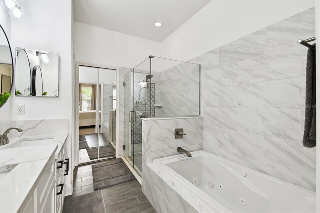 10011 Parley Dr, Tampa, FL 33626 - ensuite bathroom with ensuite bathroom, a sink, a whirlpool tub, a shower stall, and double vanity