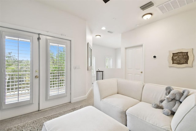 10011 Parley Dr, Tampa, FL 33626 - carpeted living room featuring french doors, visible vents, and plenty of natural light