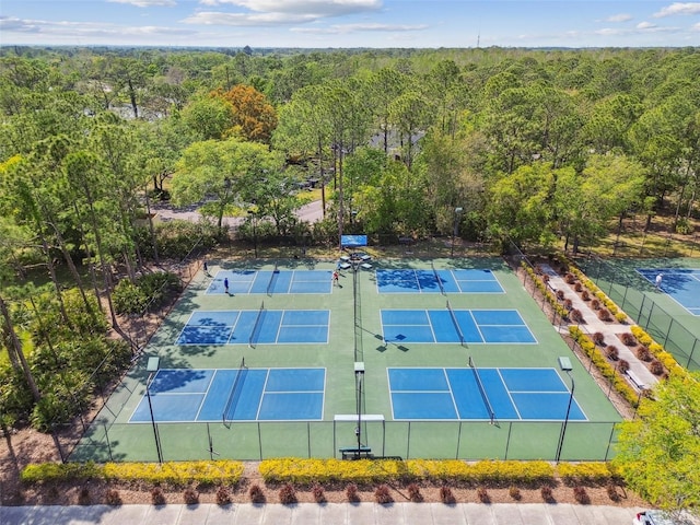 10011 Parley Dr, Tampa, FL 33626 - view of tennis court featuring a forest view and fence