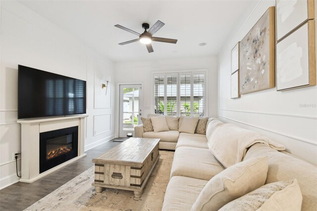 10011 Parley Dr, Tampa, FL 33626 - living area featuring wood finished floors, a ceiling fan, and a glass covered fireplace