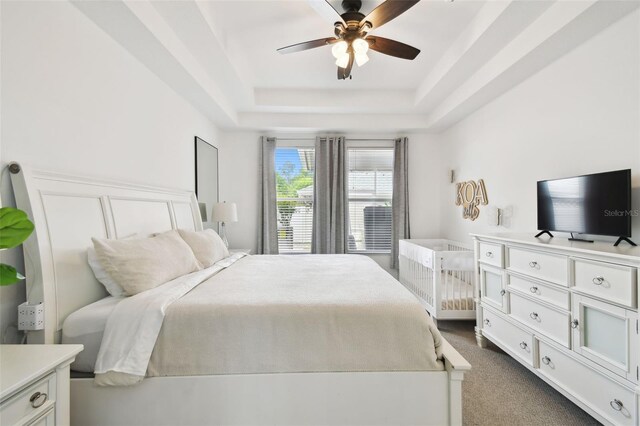 10011 Parley Dr, Tampa, FL 33626 - bedroom featuring a tray ceiling, dark carpet, and a ceiling fan
