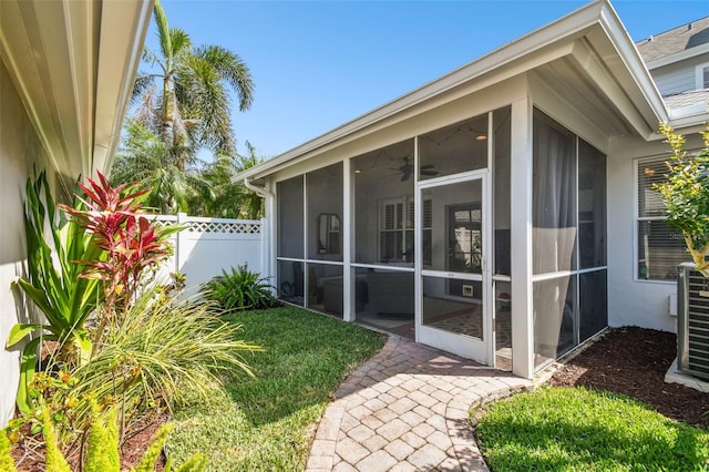 10011 Parley Dr, Tampa, FL 33626 - view of home's exterior with fence, a sunroom, stucco siding, and central air condition unit