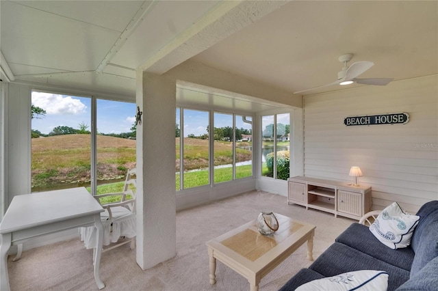 sunroom with a healthy amount of sunlight, a ceiling fan, and an outdoor hangout area