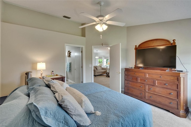 bedroom featuring light colored carpet, ceiling fan, lofted ceiling, and visible vents