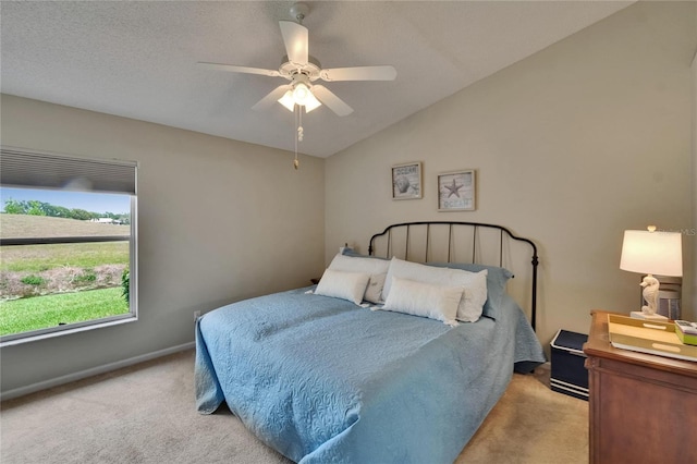 bedroom with carpet floors, baseboards, ceiling fan, and lofted ceiling
