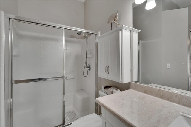 full bathroom with toilet, a shower stall, and vanity