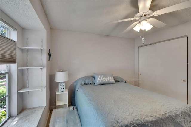 bedroom featuring carpet flooring, ceiling fan, and multiple windows