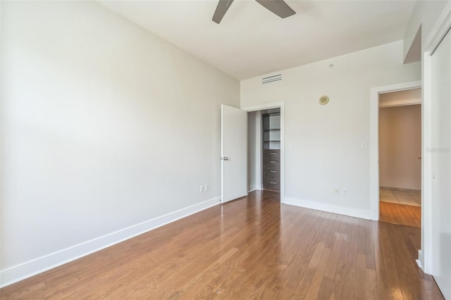 1120 E Kennedy Blvd Unit 615, Tampa, FL 33602 - unfurnished bedroom with ceiling fan, visible vents, wood-type flooring, and baseboards