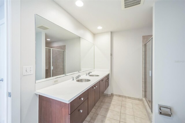 1120 E Kennedy Blvd Unit 615, Tampa, FL 33602 - bathroom with a sink, visible vents, a shower stall, and double vanity
