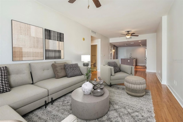 1120 E Kennedy Blvd Unit 615, Tampa, FL 33602 - living area with visible vents, baseboards, a ceiling fan, and wood finished floors