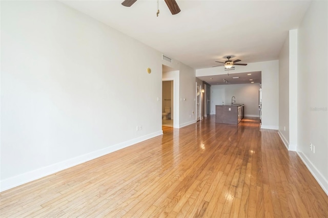 1120 E Kennedy Blvd Unit 615, Tampa, FL 33602 - unfurnished living room featuring light wood finished floors, visible vents, baseboards, and a ceiling fan