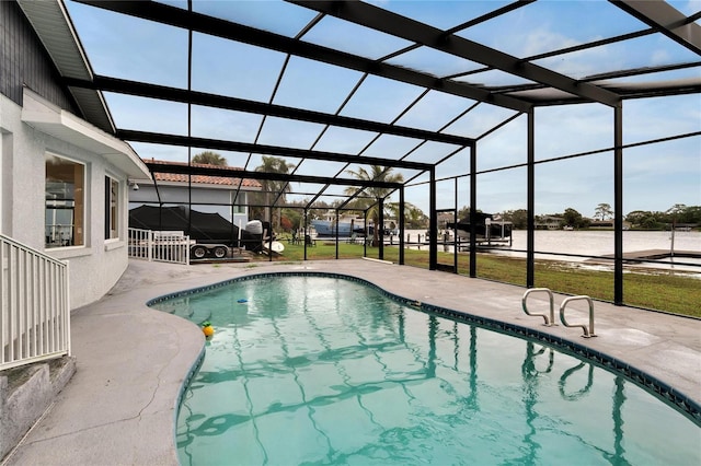 outdoor pool featuring glass enclosure, a patio, and a lawn
