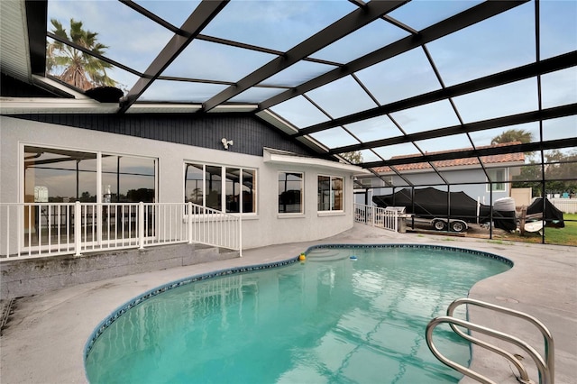 outdoor pool with a lanai and a patio area