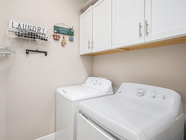 laundry area featuring independent washer and dryer and cabinet space