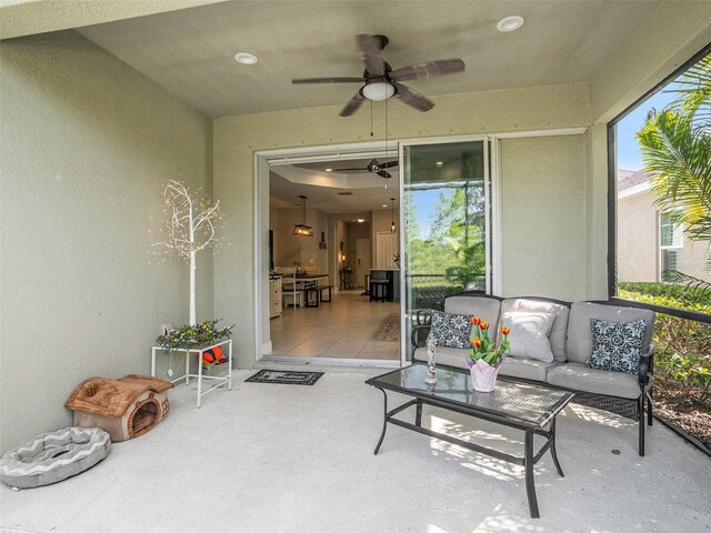 sunroom featuring an outdoor living space and ceiling fan