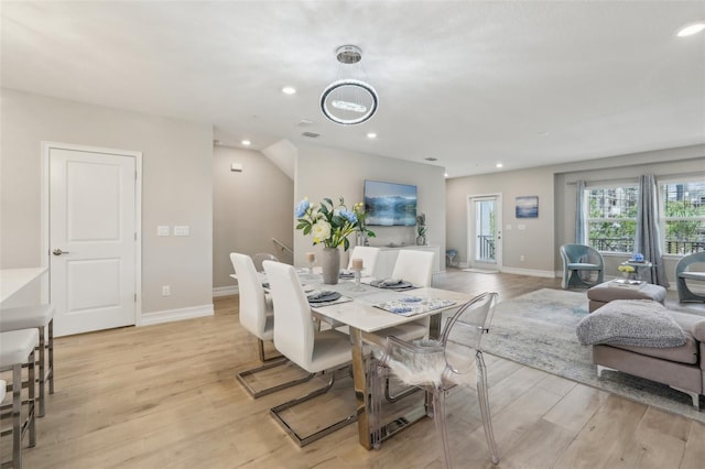 dining room with recessed lighting, light wood finished floors, and baseboards