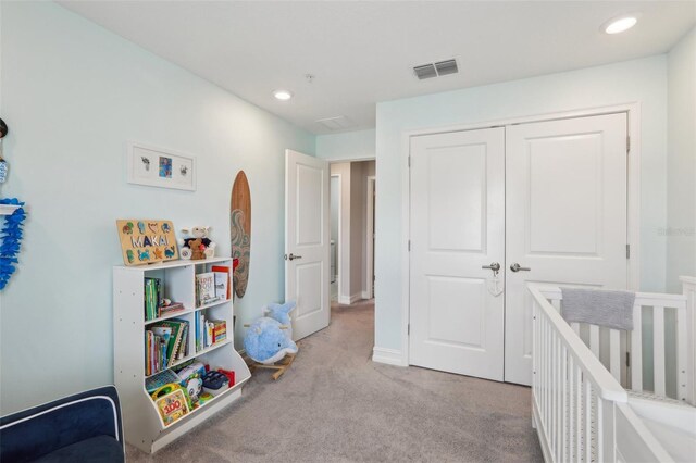 bedroom with a closet, baseboards, recessed lighting, carpet floors, and visible vents